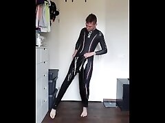 Boy putting on PVC over his wetsuit